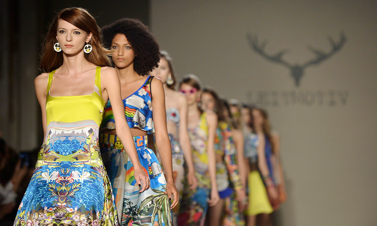 Models present creations from the Leitmotiv collection during the 2015 Spring / Summer Milan Fashion Week on September 22, 2014 in Milan. AFP PHOTO / TIZIANA FABI